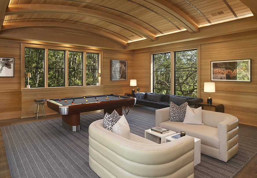 Specialty game room with vaulted ceiling design, showcasing a unique space in a custom home.