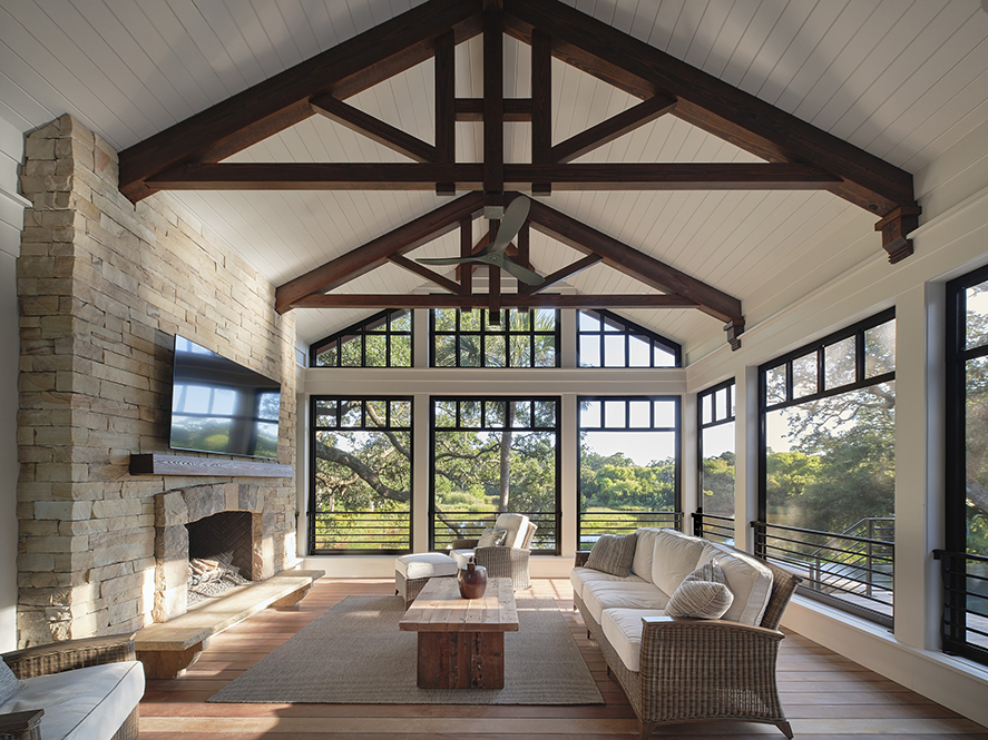 Interior of a custom Kiawah Island retreat showcasing vaulted ceilings with rustic beams, expansive windows, and nature views by Camens Architectural Group.