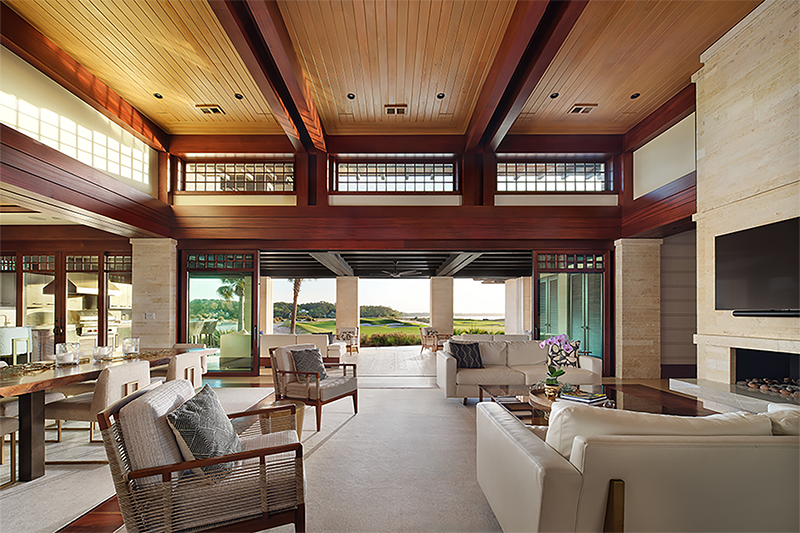 Elegant main living space with wood-beamed ceilings and panoramic views, exemplifying modern architectural home design in a desert craftsman style