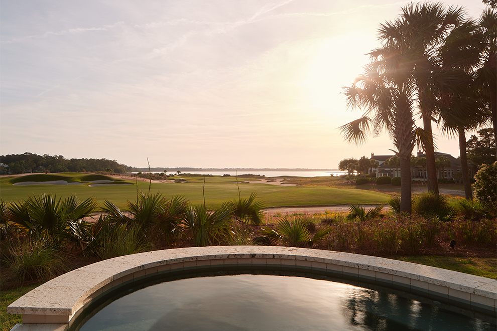 Curved pool overlooking golf course and horizon, illustrating pool design as part of Marc Camens’ residential architecture process.