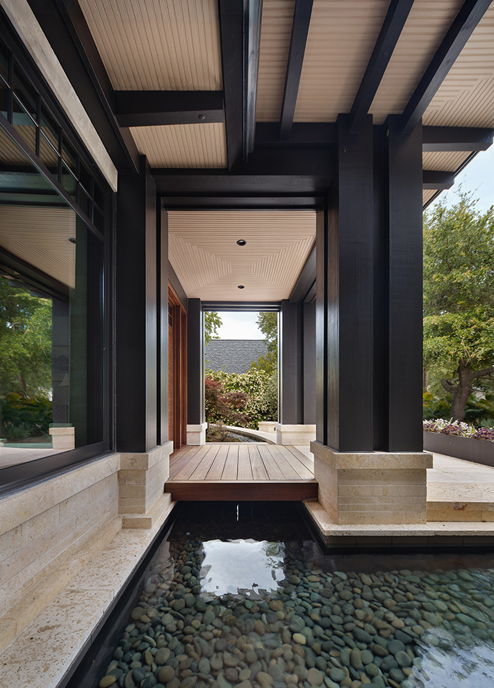 Architectural detail with water feature and stone design, showing pool design as a thoughtful element in the residential architecture process.